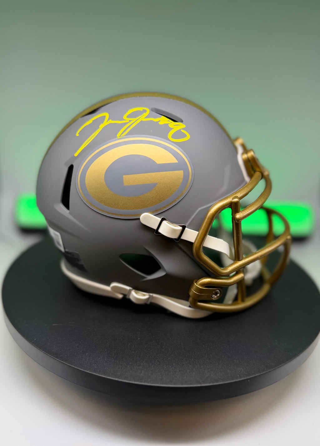 Autographed gray Packers mini helmet with yellow signature