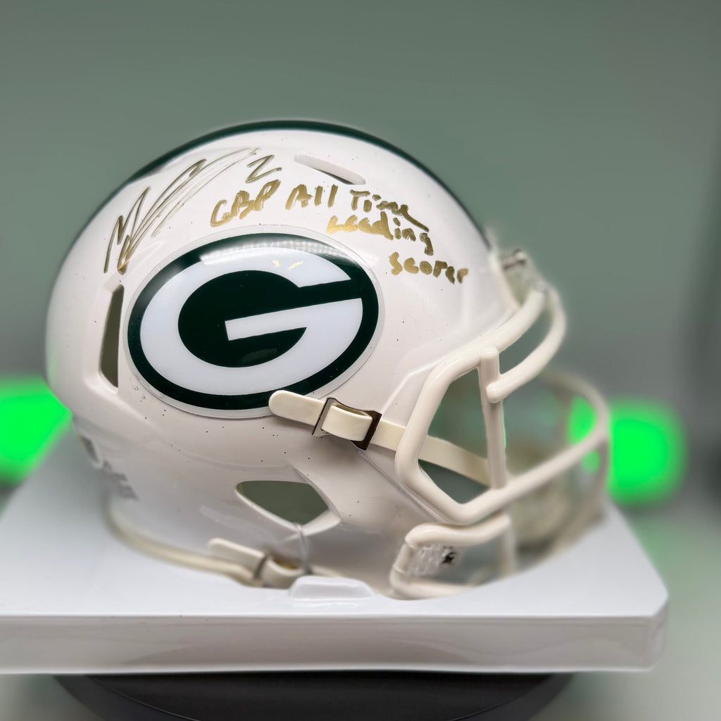 Autographed white Packers mini helmet with gold writing