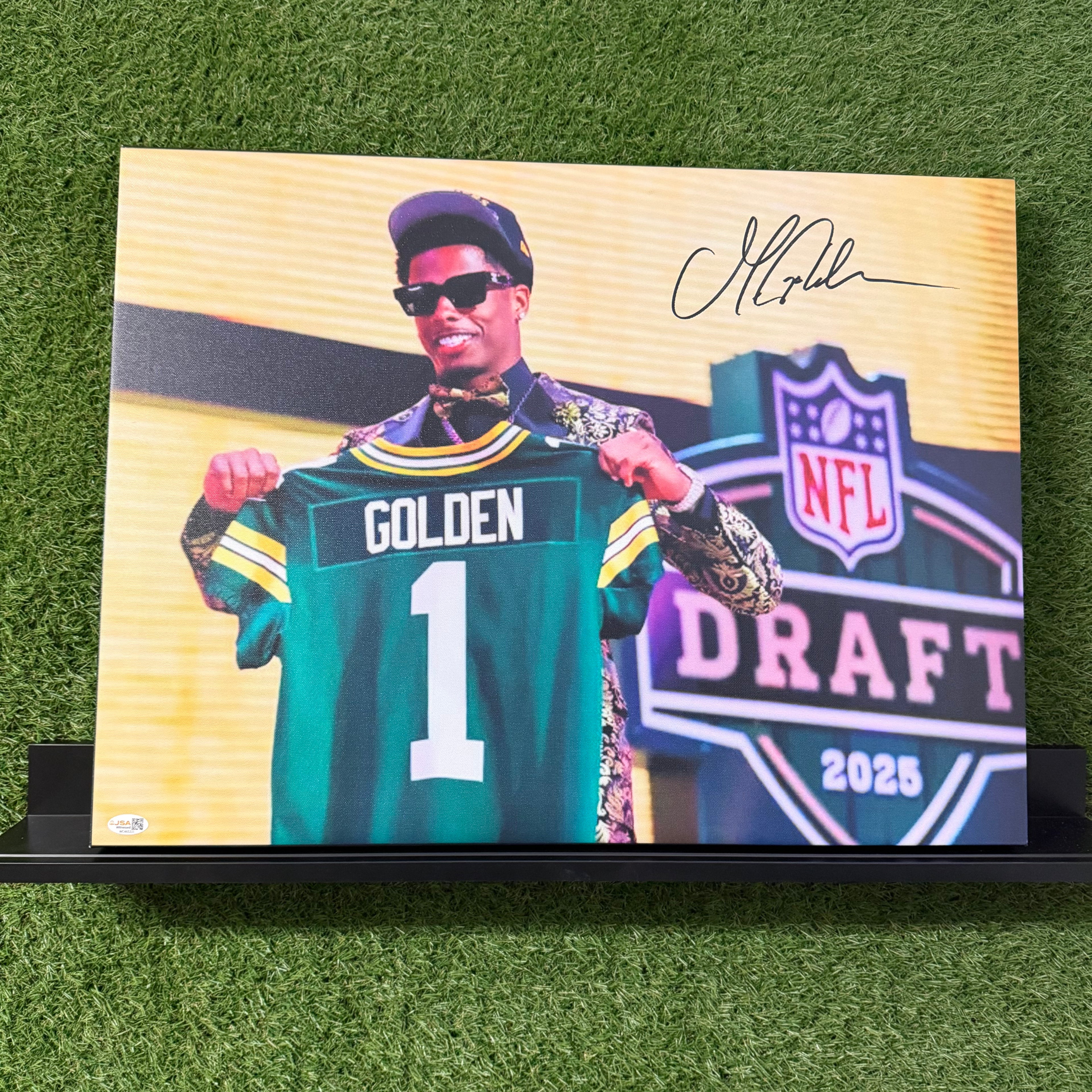 Plaque of a person holding a sports jersey with 'NFL Draft 2023' and 'Golden' on a grass background