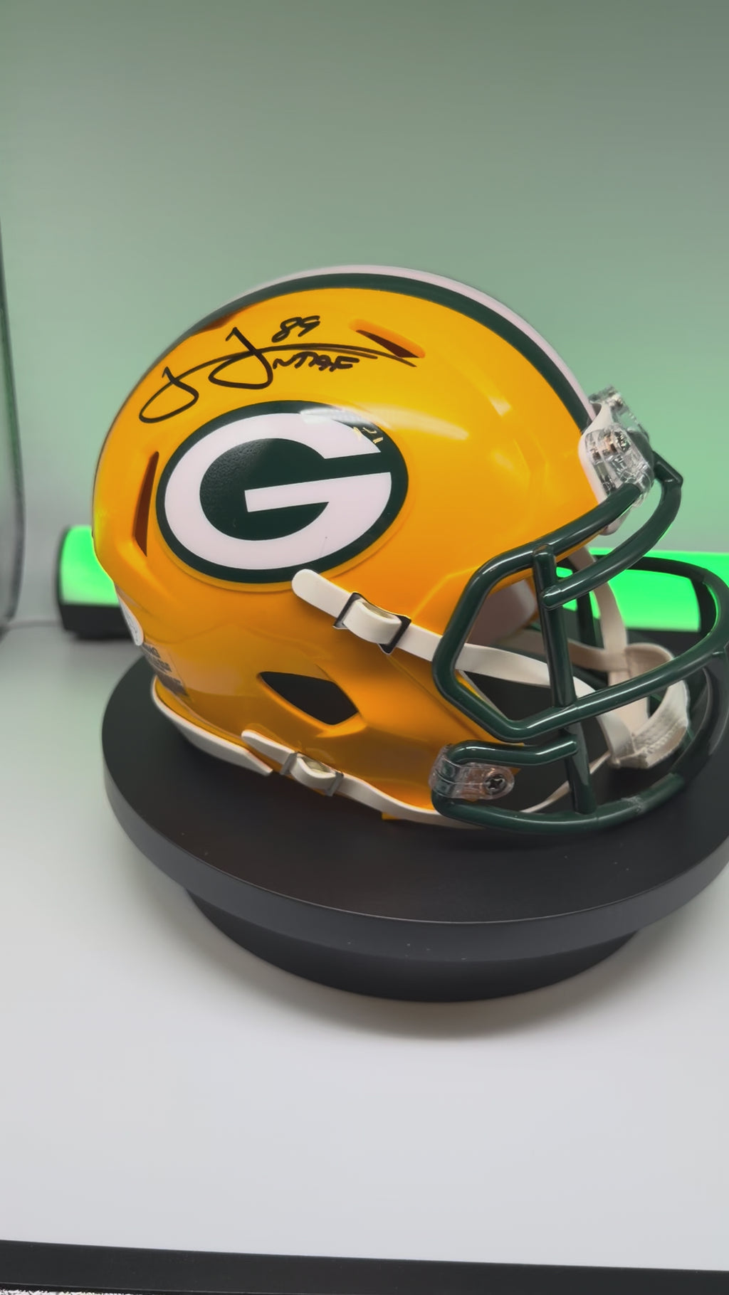 Video of autographed Packers mini helmet spinning on a turn table